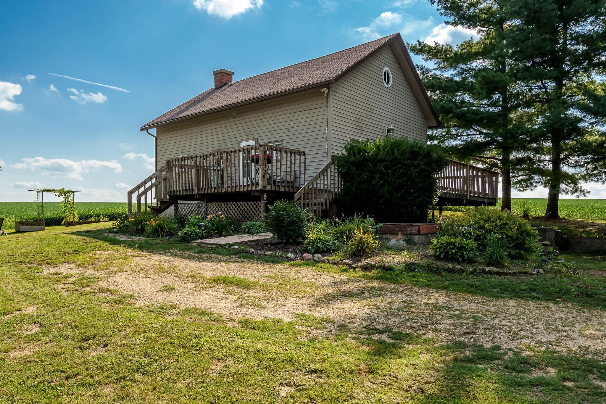 6913 West Wagner Road German Valley, IL 61039 - Photo 3 of 54 a front view of a house with garden