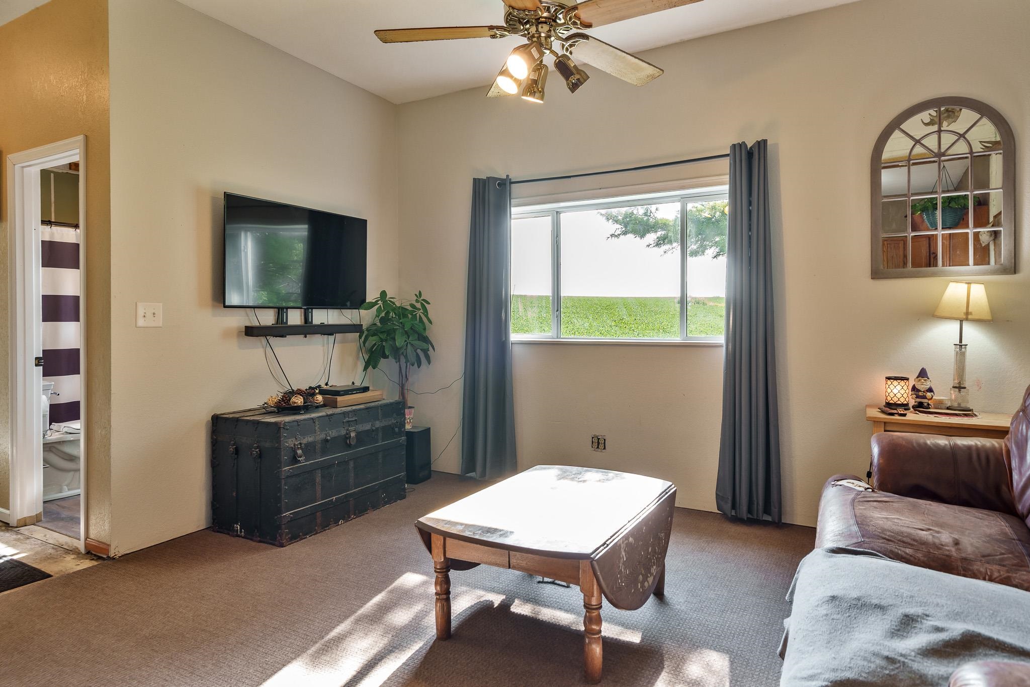 6913 West Wagner Road German Valley, IL 61039 - Photo 38 of 54 a living room with furniture a window and a flat screen tv