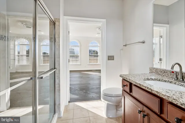 a view of a big house with a big yard and large trees