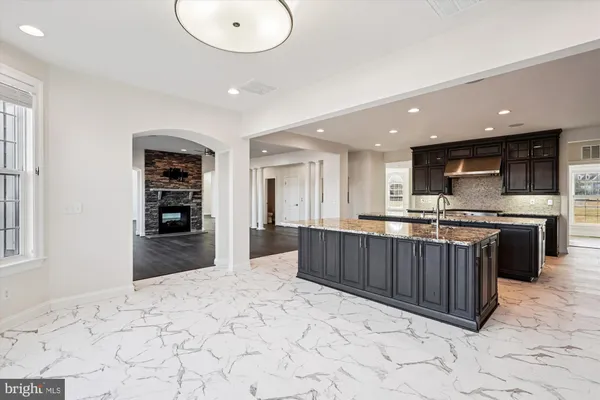 a kitchen with stainless steel appliances granite countertop a granite counter tops and a refrigerator