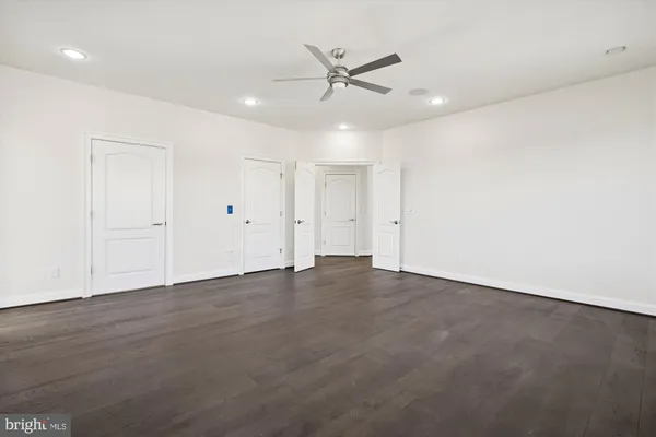 a kitchen with granite countertop a stove a sink and a microwave