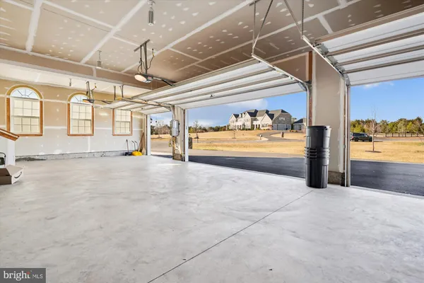 a view of a big room with wooden floor and a ceiling fan