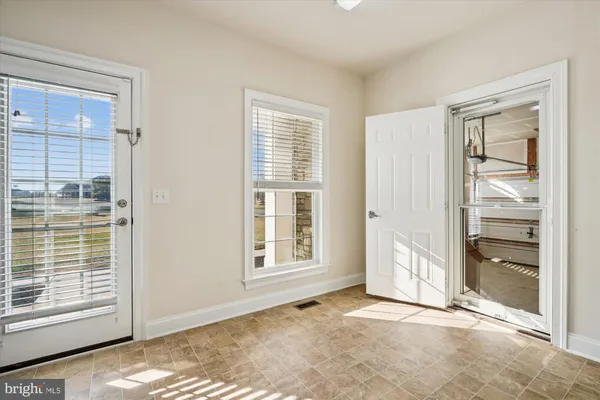 a view of an empty room and a bathroom