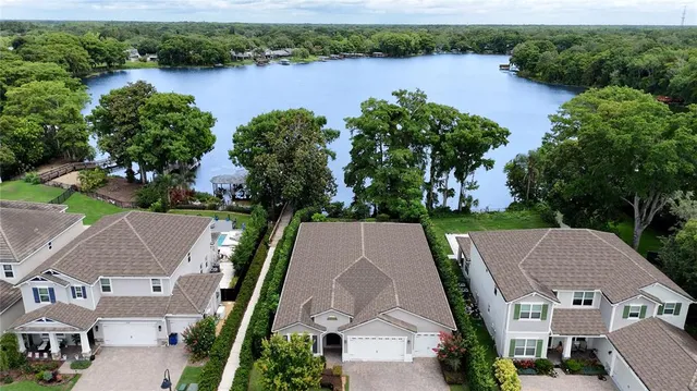 an aerial view of house with yard and lake view