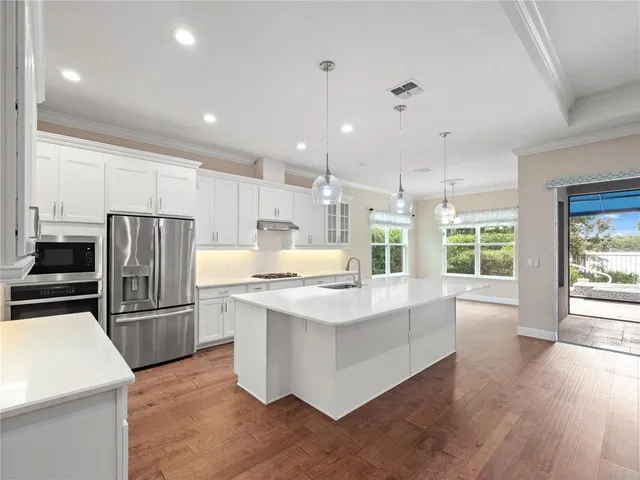 a view of a kitchen with a refrigerator and a window