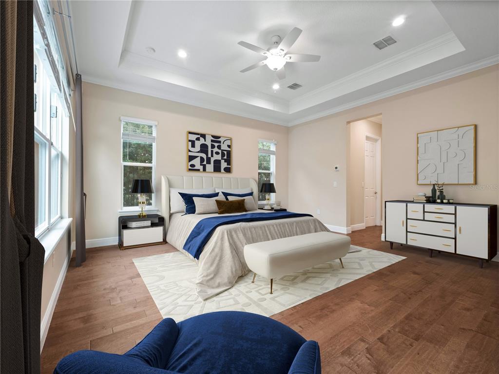 2922 Reef Knot Place Winter Park, FL 32792 - Photo 20 of 49 a bedroom with a large bed and a chandelier