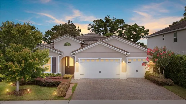 a view of a house with a yard and potted plants