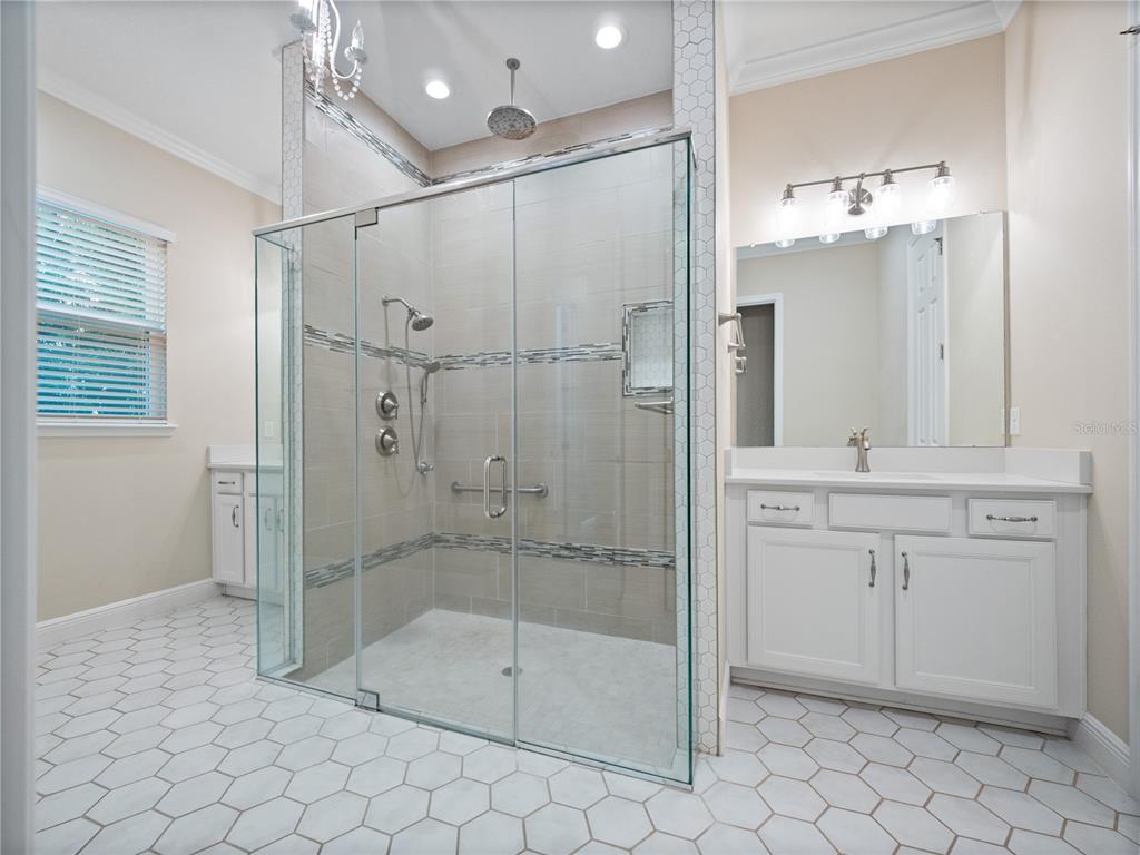 2922 Reef Knot Place Winter Park, FL 32792 - Photo 22 of 49 a bathroom with a shower sink and mirror