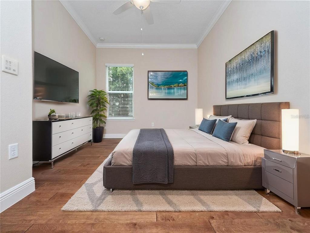2922 Reef Knot Place Winter Park, FL 32792 - Photo 26 of 49 a bedroom with a large bed and a flat screen tv