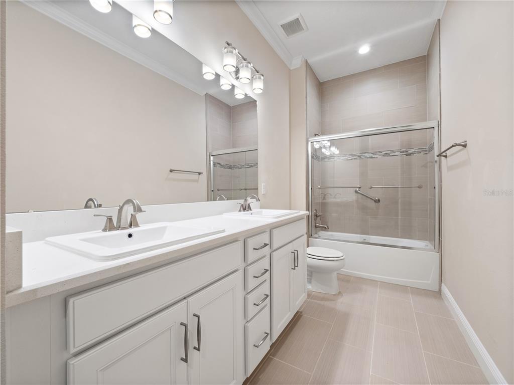 2922 Reef Knot Place Winter Park, FL 32792 - Photo 27 of 49 a bathroom with a double vanity sink a toilet and shower