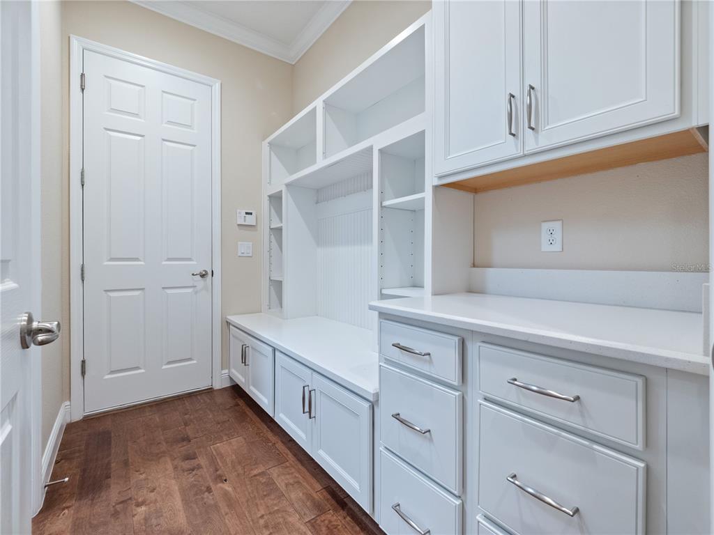 2922 Reef Knot Place Winter Park, FL 32792 - Photo 31 of 49 a kitchen with white cabinets and white appliances