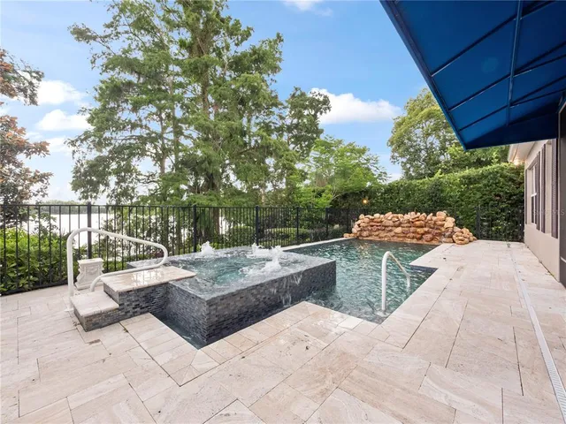 a view of swimming pool with outdoor seating and plants