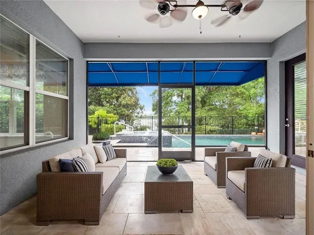 a living room with furniture and a floor to ceiling window
