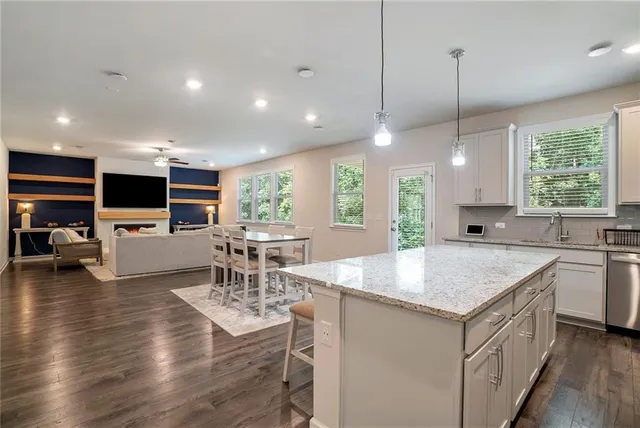 a kitchen with stainless steel appliances granite countertop a stove and center island