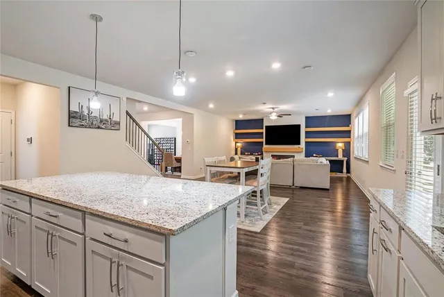 a open kitchen with sink table and chairs