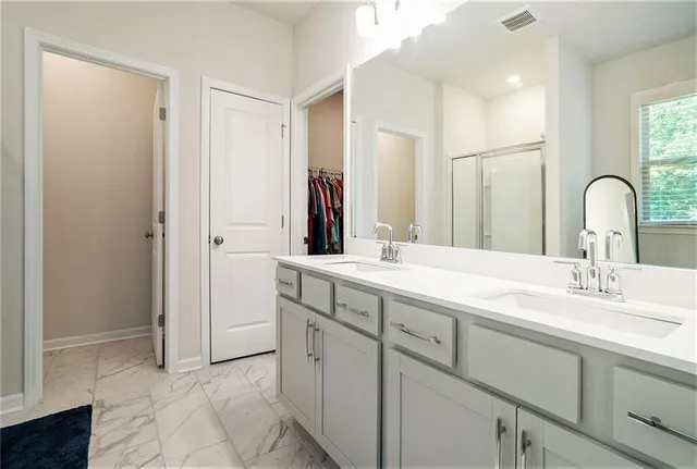 a bathroom with a double vanity sink mirror and