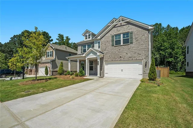 a front view of a house with a yard