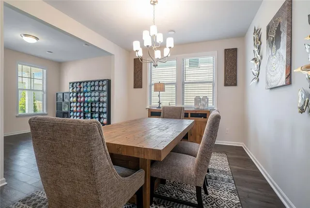 a view of a dining room with furniture a chandelier and wooden floor