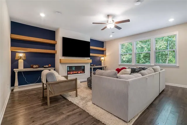 a living room with furniture a fireplace and a flat screen tv
