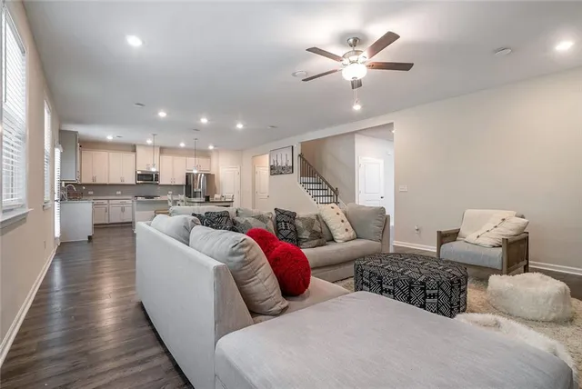a living room with furniture and kitchen view