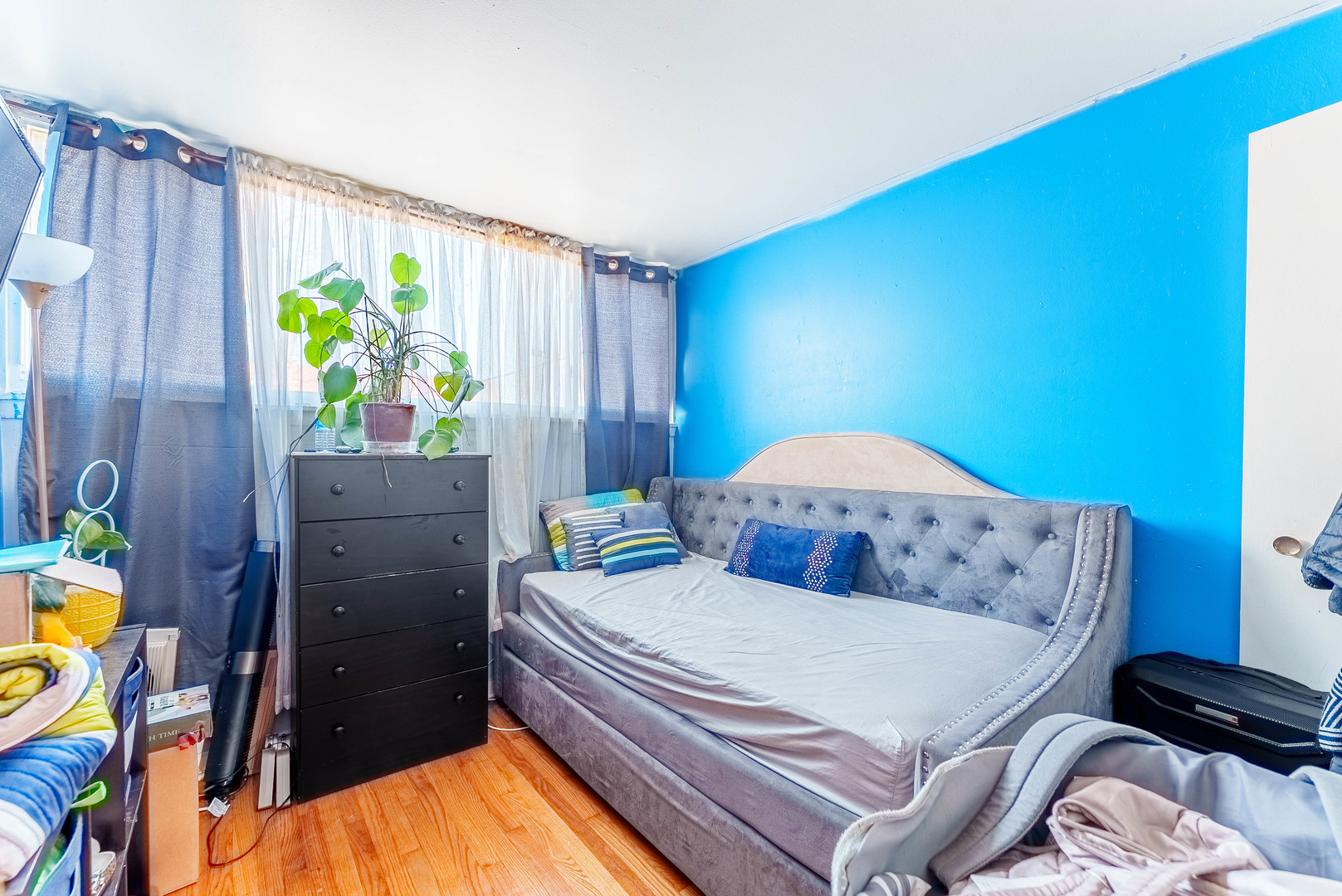 4148 West 19th Street Chicago, IL 60623 - Photo 12 of 21 a bedroom with a bed and a dresser