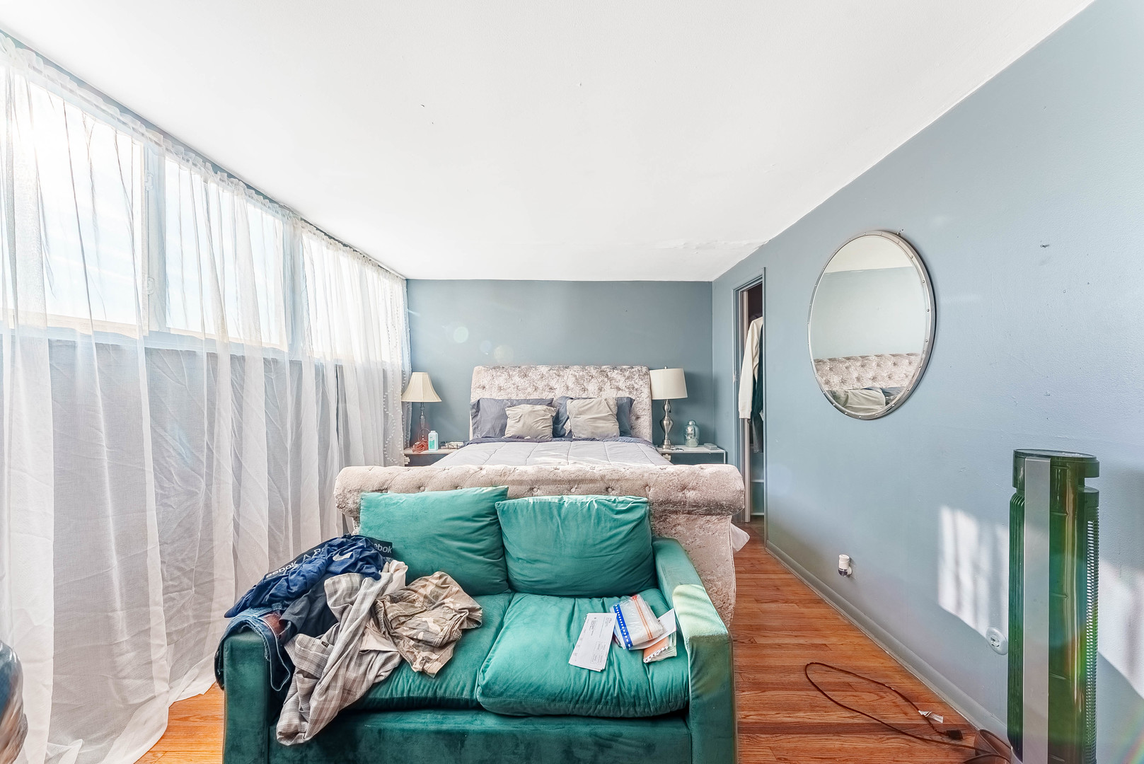 4148 West 19th Street Chicago, IL 60623 - Photo 15 of 21 a bed sitting in a bedroom next to a window with a chandelier