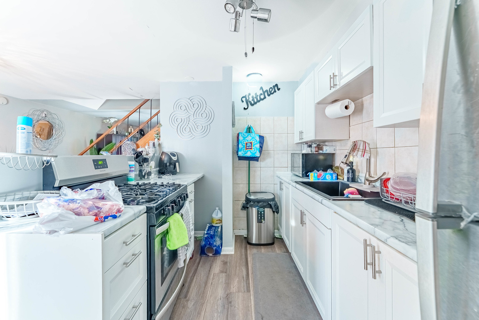 4148 West 19th Street Chicago, IL 60623 - Photo 5 of 21 a kitchen with a white cabinets stove and refrigerator