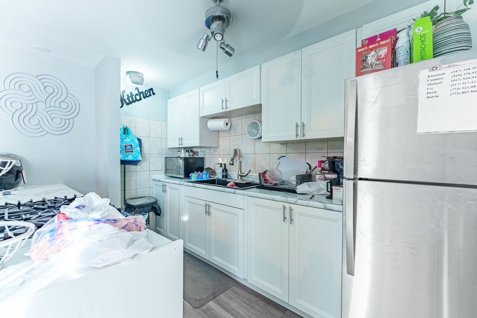4148 West 19th Street Chicago, IL 60623 - Photo 7 of 21 a kitchen with a refrigerator and a sink