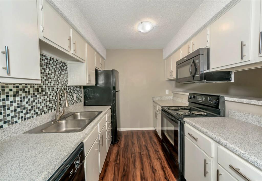 3815 Stuart Road, Unit 2BR2BATH Denton, TX 76209 - Photo 5 of 15 a kitchen with a sink stove and refrigerator