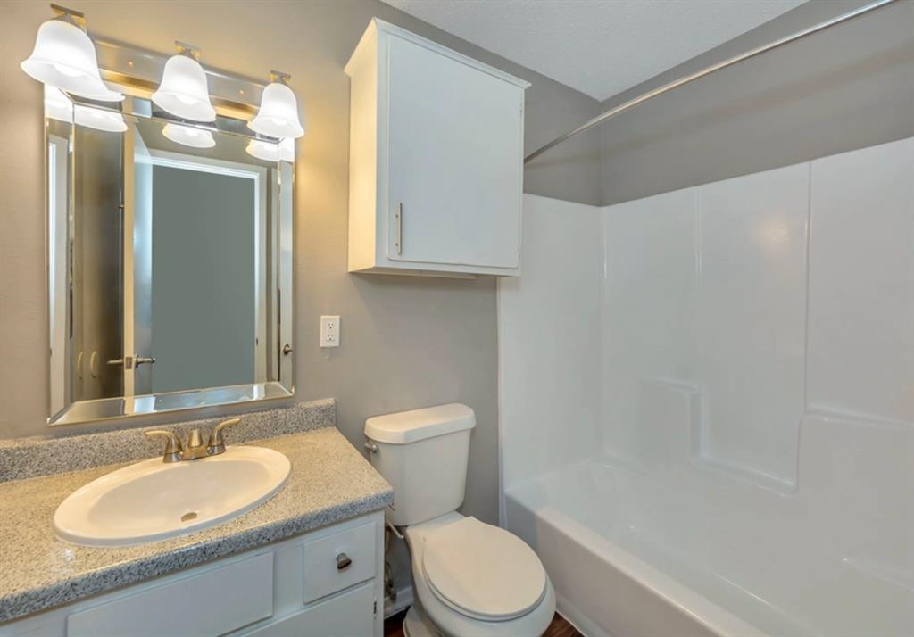 3815 Stuart Road, Unit 2BR2BATH Denton, TX 76209 - Photo 6 of 15 a bathroom with a sink a toilet and shower