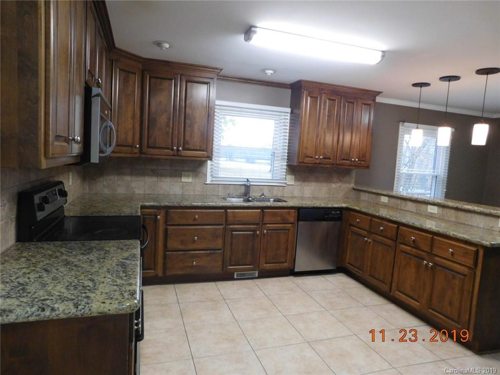 4020 Sincerity Road Monroe, NC 28110 - Photo 3 of 23 a kitchen with stainless steel appliances granite countertop a sink stove and cabinets
