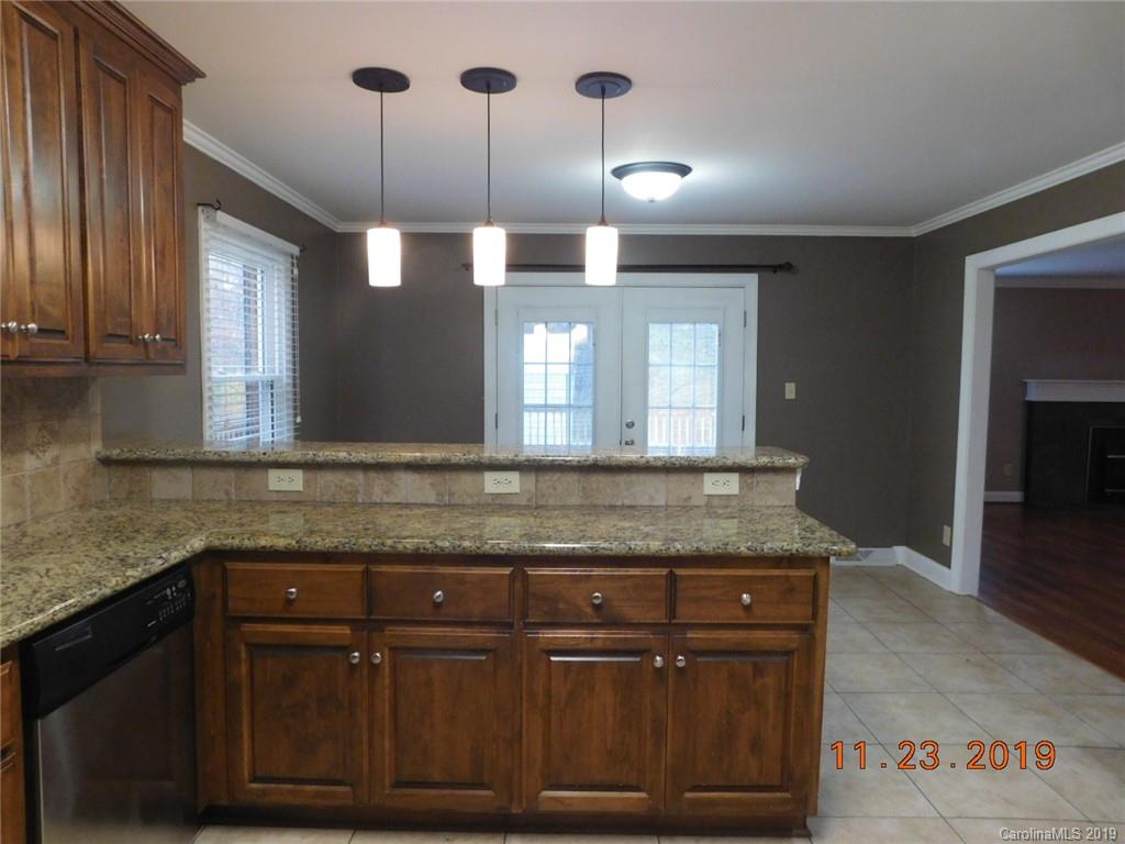 4020 Sincerity Road Monroe, NC 28110 - Photo 4 of 23 a bathroom with a granite countertop sink a vanity and a large mirror