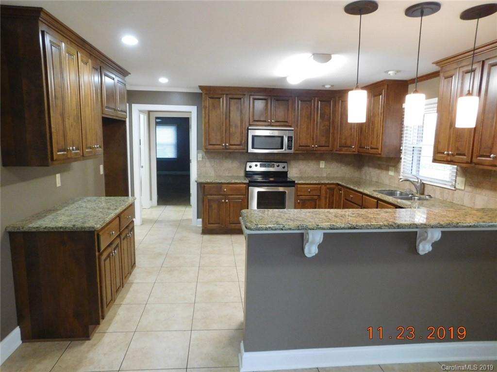 4020 Sincerity Road Monroe, NC 28110 - Photo 5 of 23 a kitchen with stainless steel appliances granite countertop a sink a stove and a refrigerator