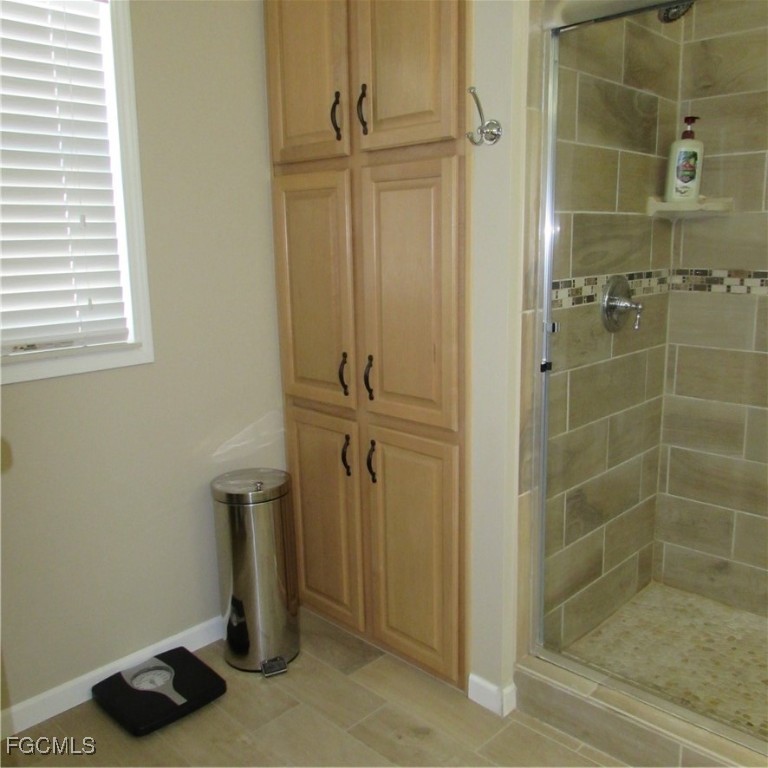 5371 Blue Crab Circle, Unit 1 Bokeelia, FL 33922 - Photo 19 of 44 a bathroom with a bathtub
