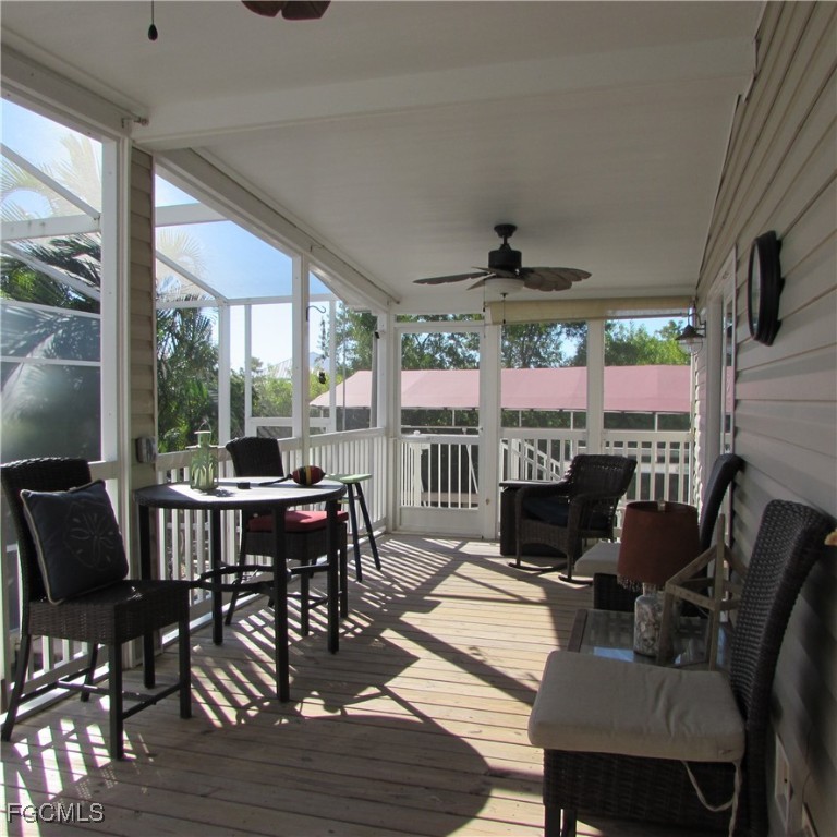 5371 Blue Crab Circle, Unit 1 Bokeelia, FL 33922 - Photo 22 of 44 a view of a dining room with furniture large windows and wooden floor