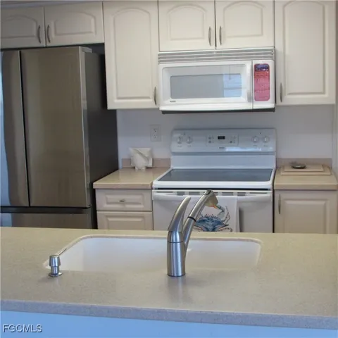a kitchen with appliances and cabinets