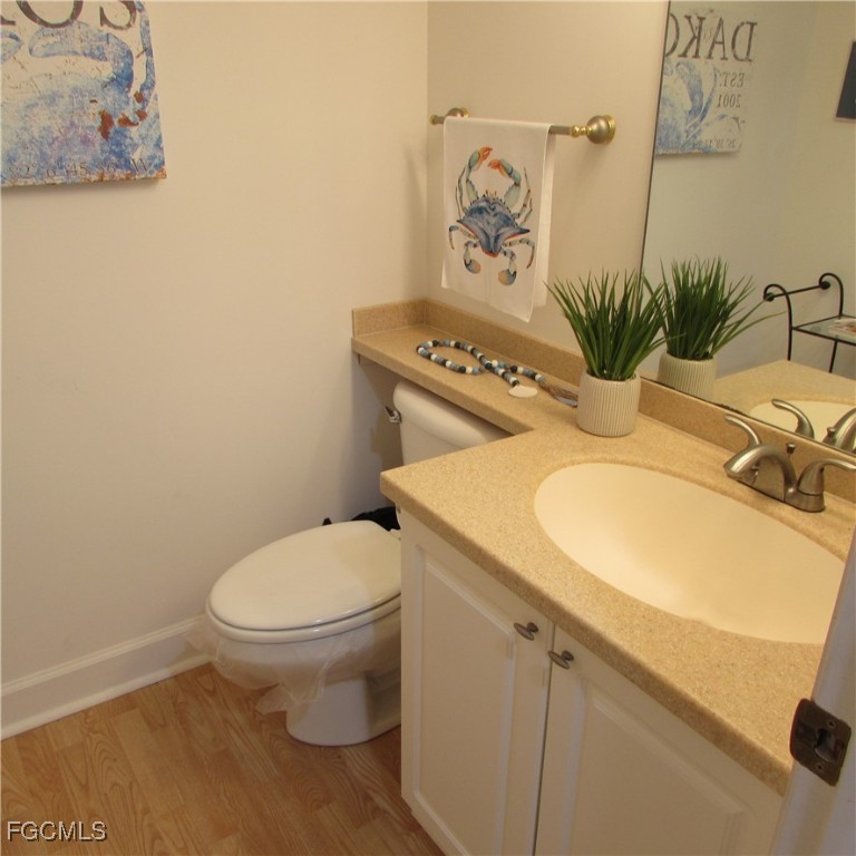 5371 Blue Crab Circle, Unit 1 Bokeelia, FL 33922 - Photo 38 of 44 a bathroom with a toilet and a sink