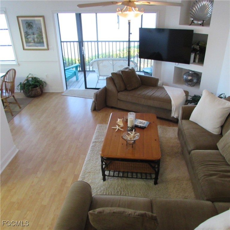5371 Blue Crab Circle, Unit 1 Bokeelia, FL 33922 - Photo 39 of 44 a living room with furniture and a flat screen tv