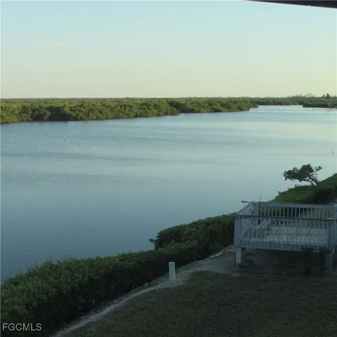 a large bed sitting in a bedroom next to a window