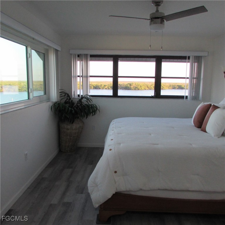 5371 Blue Crab Circle, Unit 1 Bokeelia, FL 33922 - Photo 44 of 44 a bedroom with a bed and a large window