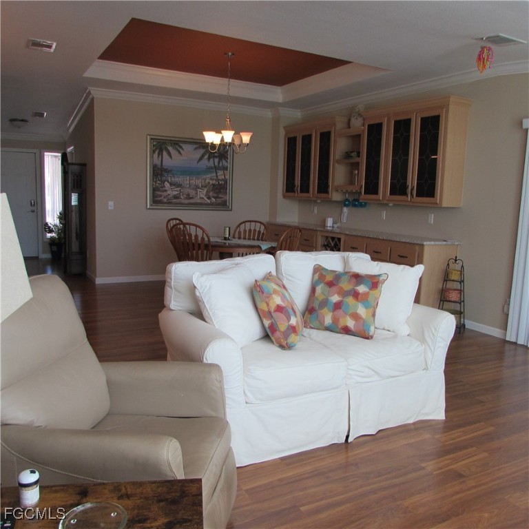 5371 Blue Crab Circle, Unit 1 Bokeelia, FL 33922 - Photo 9 of 44 a living room with furniture and a wooden floor