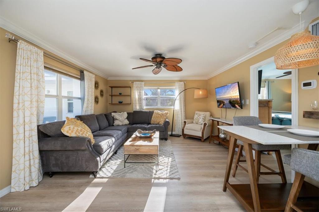780 10th Avenue South, Unit 24 Naples, FL 34102 - Photo 1 of 15 a living room with furniture a flat screen tv and a large window