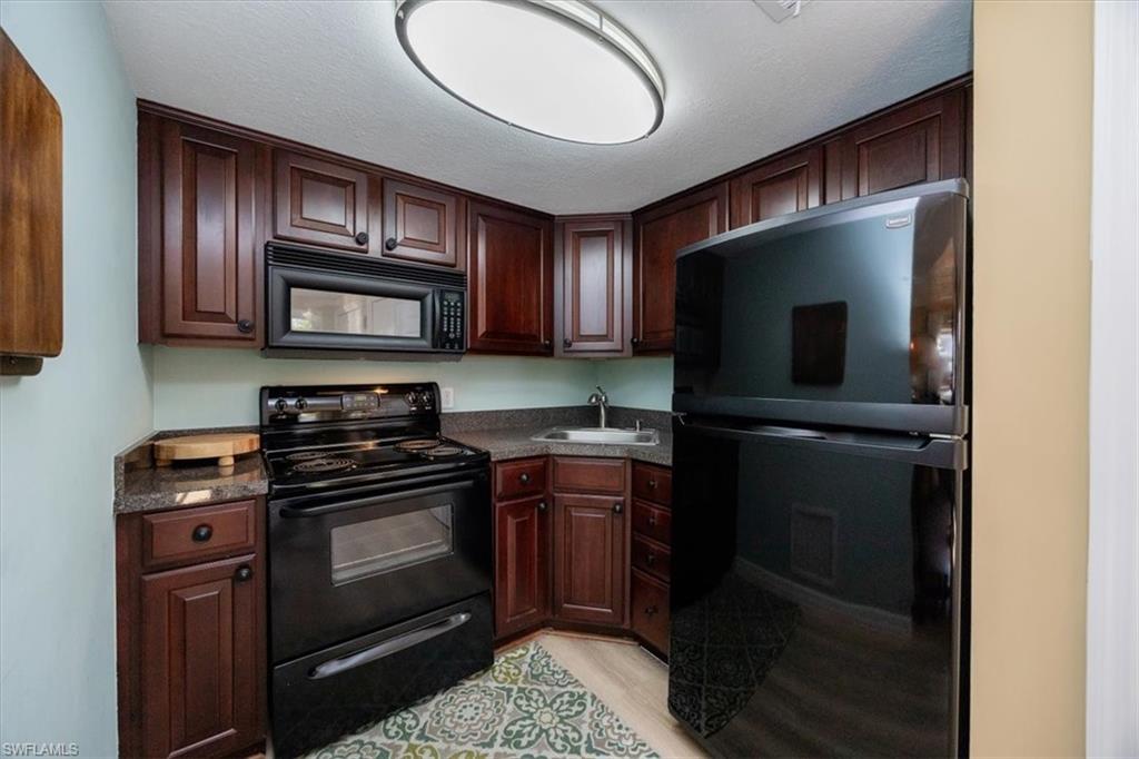 780 10th Avenue South, Unit 24 Naples, FL 34102 - Photo 8 of 15 a kitchen with a refrigerator stove and microwave