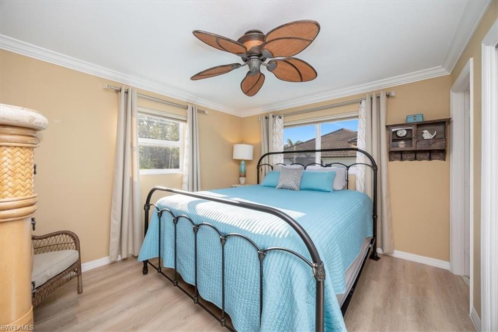 780 10th Avenue South, Unit 24 Naples, FL 34102 - Photo 9 of 15 a bedroom with a bed and a cabinets