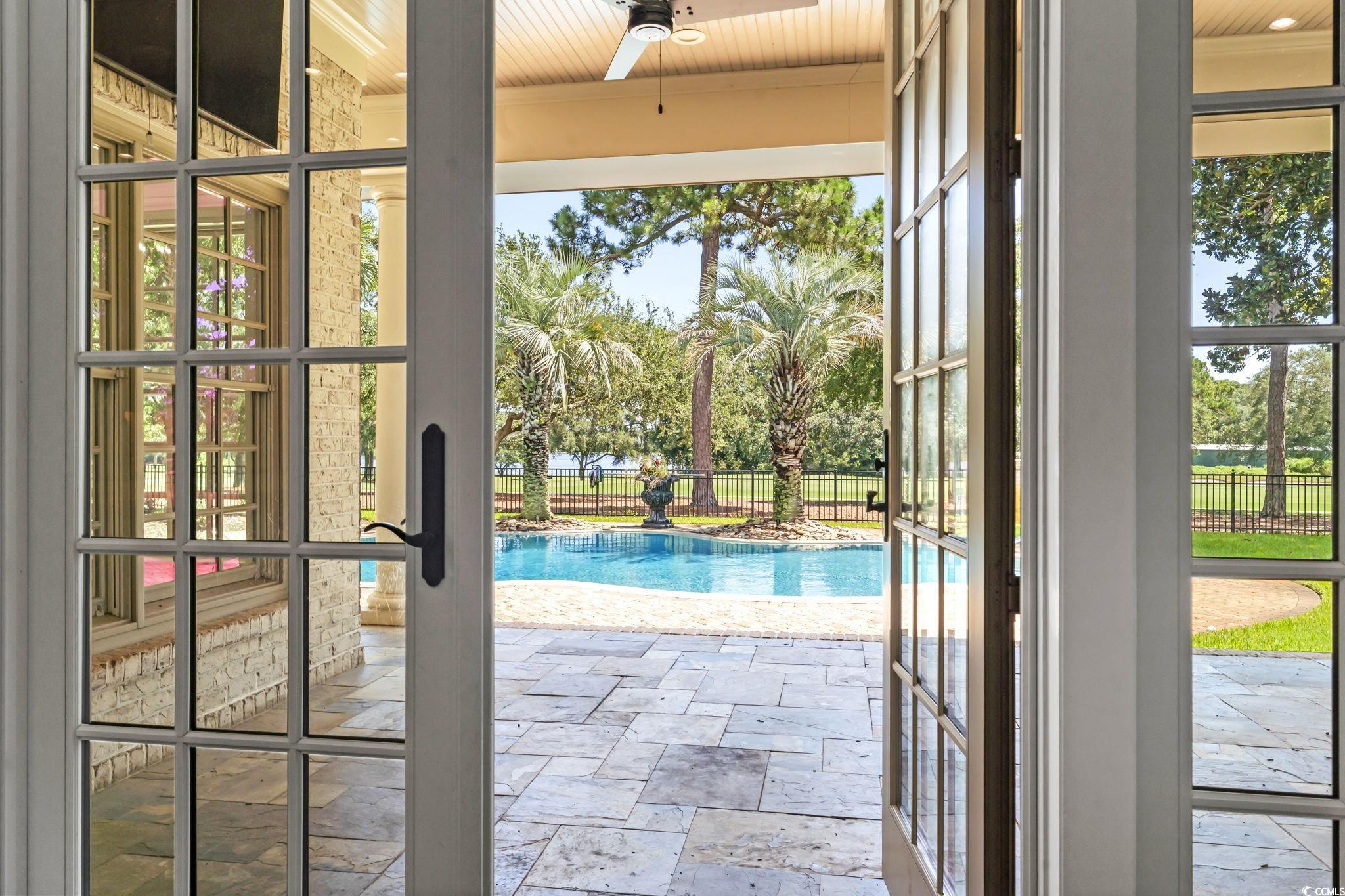 9318 Cove Drive Myrtle Beach, SC 29572 - Photo 3 of 40 Doorway to outside with french doors and stone tile flooring