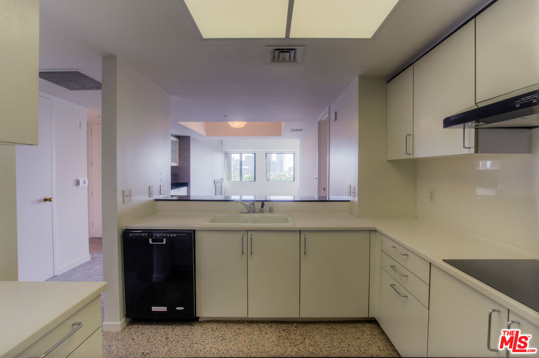 10520 Wilshire Boulevard, Unit 905 Los Angeles, CA 90024 - Photo 13 of 17 a kitchen with a sink and cabinets