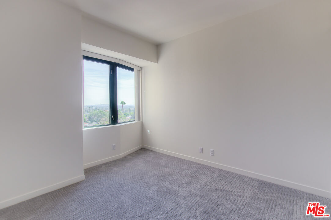 10520 Wilshire Boulevard, Unit 905 Los Angeles, CA 90024 - Photo 16 of 17 a view of an empty room with a window