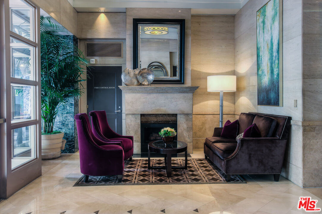 10520 Wilshire Boulevard, Unit 905 Los Angeles, CA 90024 - Photo 5 of 17 a living room with furniture and a fireplace