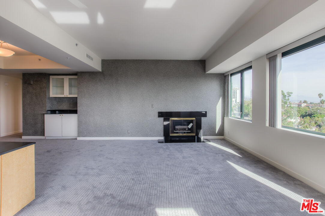 10520 Wilshire Boulevard, Unit 905 Los Angeles, CA 90024 - Photo 10 of 17 an empty room with furniture and a window