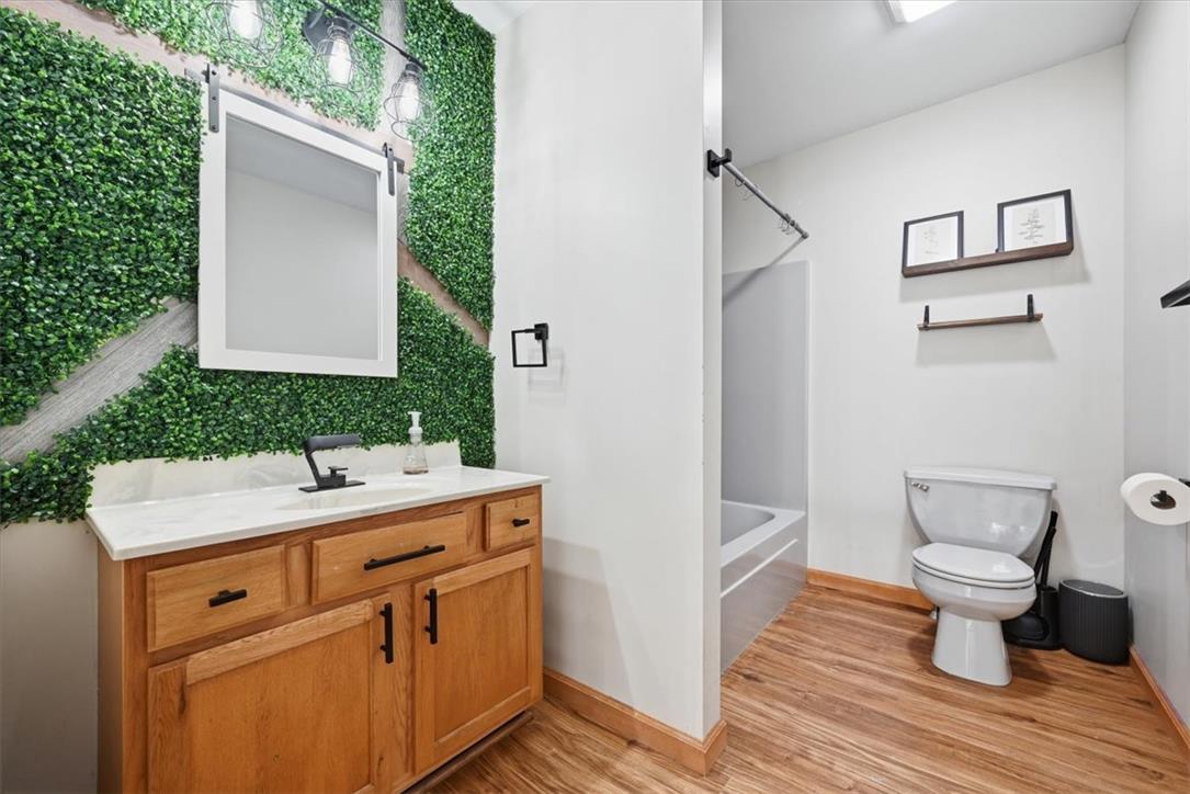 387 Blue Ridge Road Saylorsburg, PA 18353 - Photo 67 of 90 An inviting full bathroom boasts a warm wood vanity and unique green wall accents.